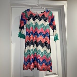 This is a multicolored casual little girls dress by sequin heart